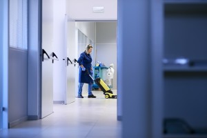 Women at workplace, professional female cleaner washing floor in