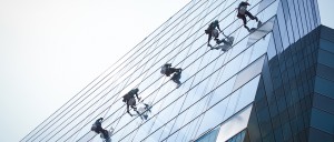 group of workers cleaning windows service on high rise building