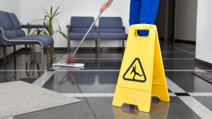 Man With Mop And Wet Floor Sign